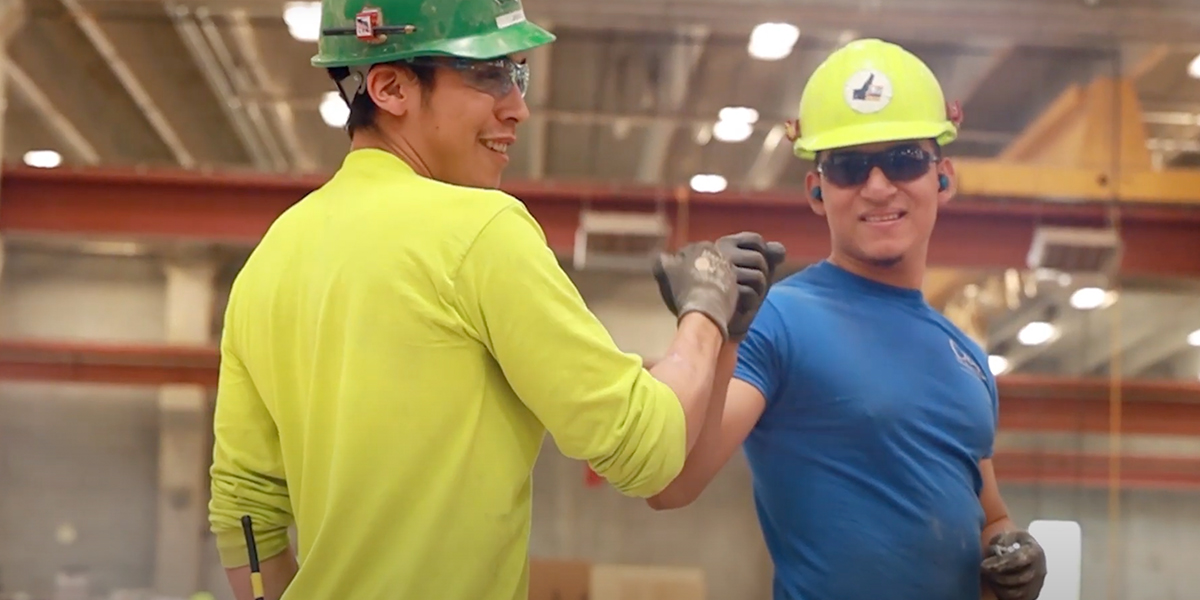 Two workers doing a fist bump