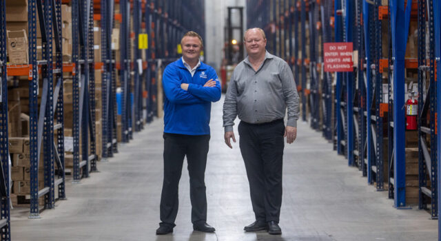 Scott and Nathan Sletten standing in warehouse