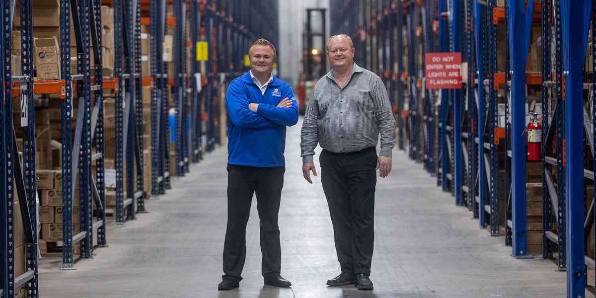 Scott and Nathan Sletten standing in warehouse