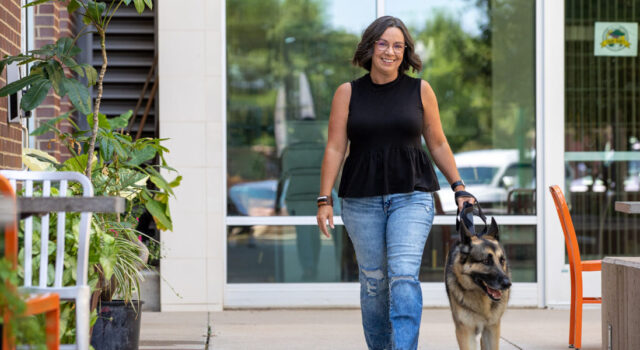 Devin McGrew walking dog in Downtown Sioux Falls