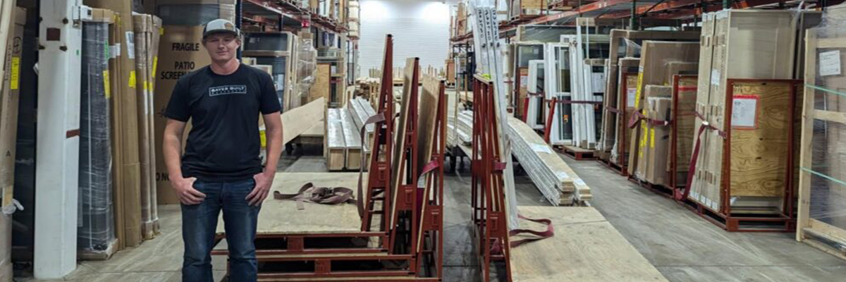Owen Vincelli stands amongst building materials