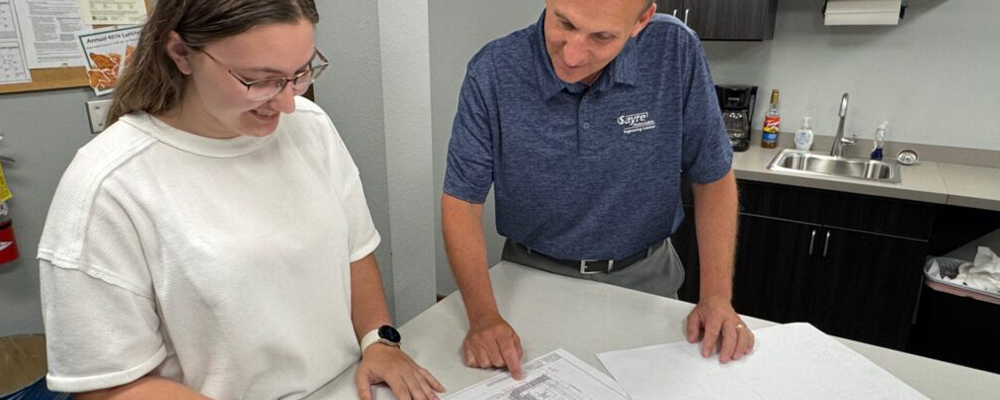 Hannah Preheim and Paul Korn look at engineering plans
