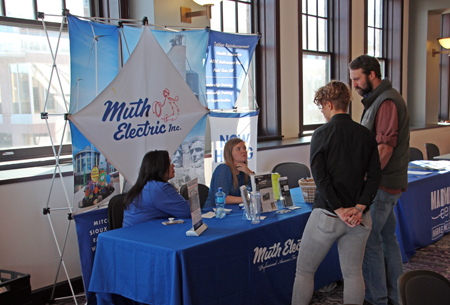 A picture of people at the Muth Electric booth at Talent Draft Day
