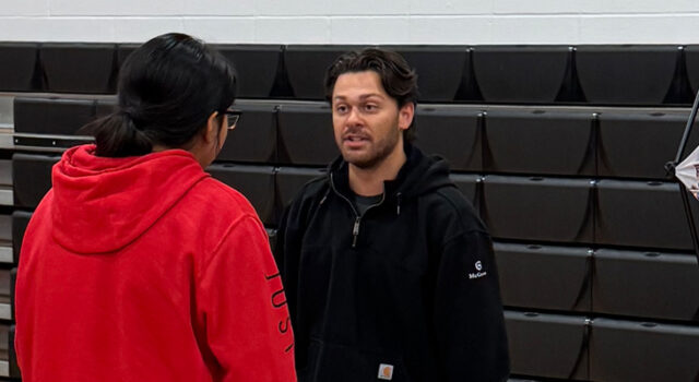 A photo of a student speaking to a representative from McGough at Talent Draft Day