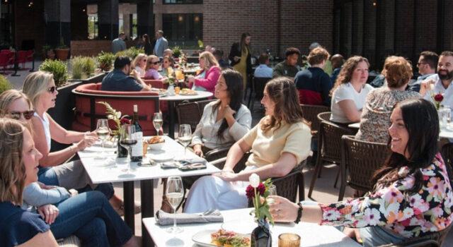A photo of patrons seated in the outdoor dining space at the Steel District