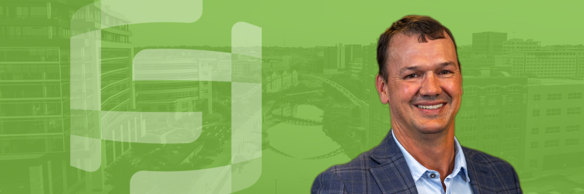 A photo of Clark Meyer with a green overlayed aerial photo of Sioux Falls in the background