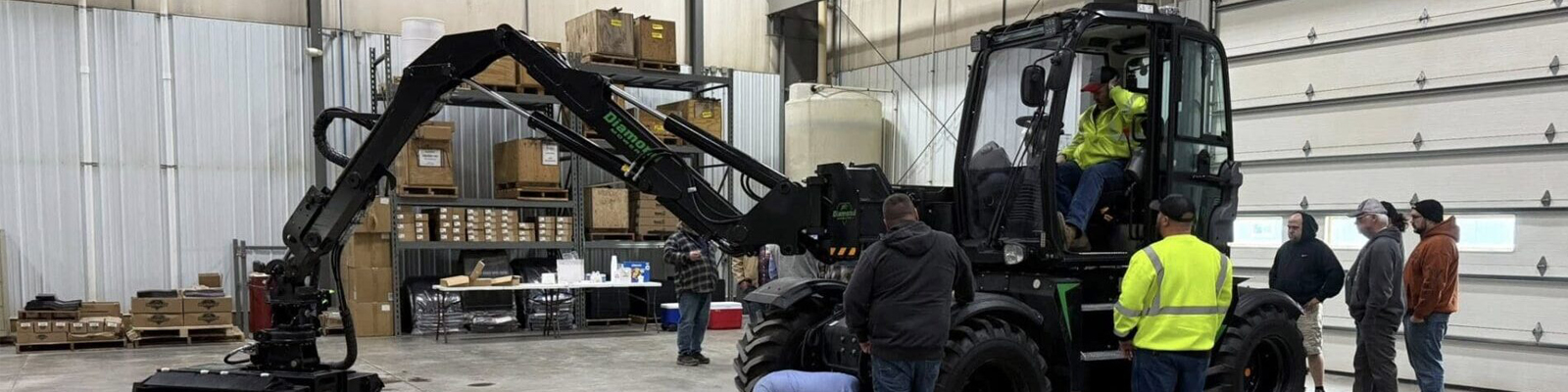 A photo of employees observing a mowing machine