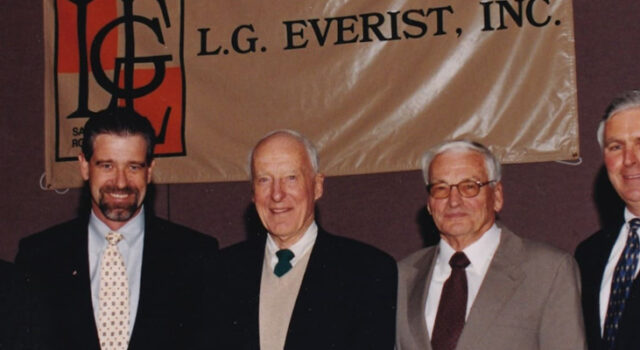 A photo of five men standing in front of an L. G. Everist, Inc. banner
