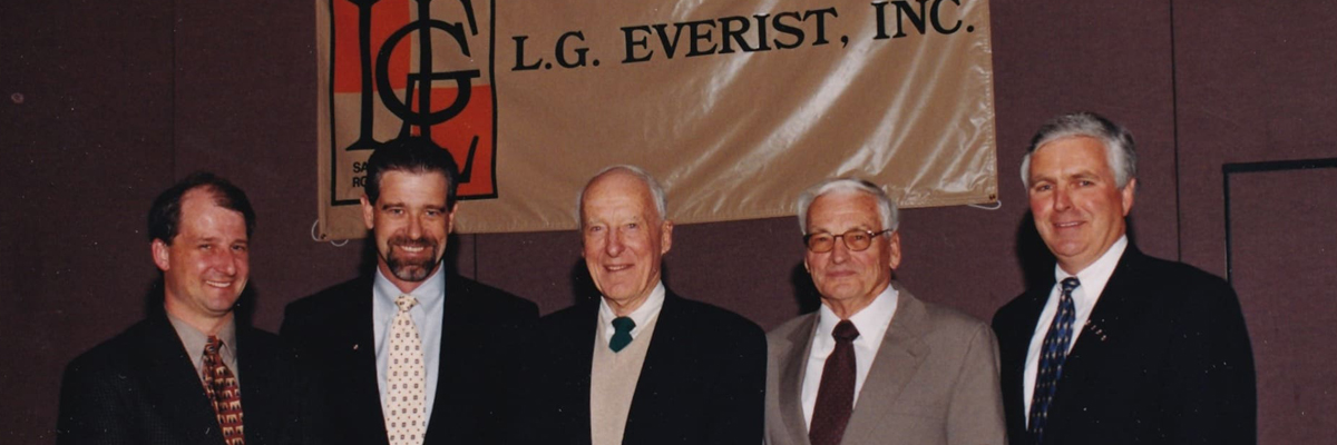 A photo of five men standing in front of an L. G. Everist, Inc. banner