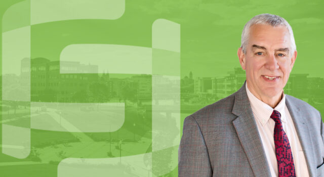 A photo of Bob Mundt with a green overlayed aerial photo of Sioux Falls in the background