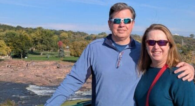 A photo of a man and a woman standing at an overlook of the Falls in Sioux Falls, SD