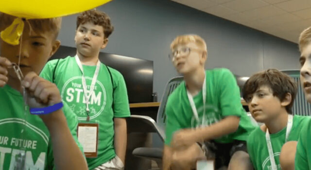 A photo of students doing an activity with balloons and paper clips at Your Future STEM Summer Day Camps 2026