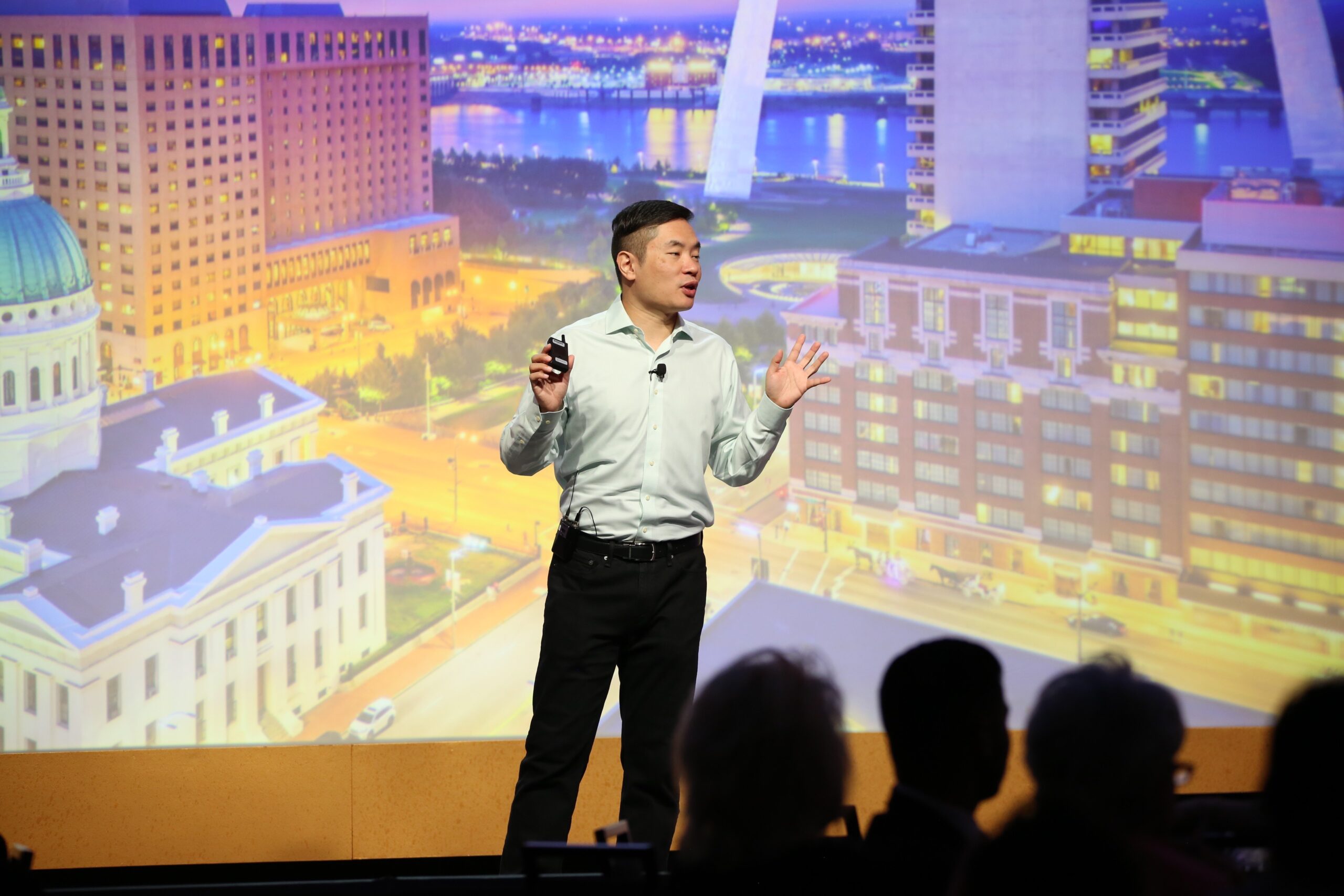 Jia Jiang speaking with a cityscape backdrop behind him